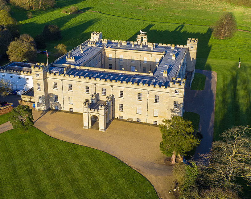 Aerial view of Syon House and its central courtyard, surrounded by parkland.